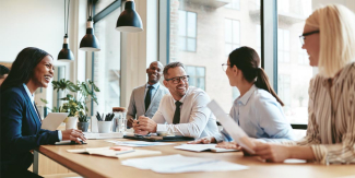 Business meeting with an individual laughing