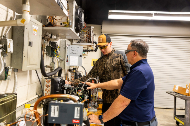 HVAC-R Instructor showing a student components